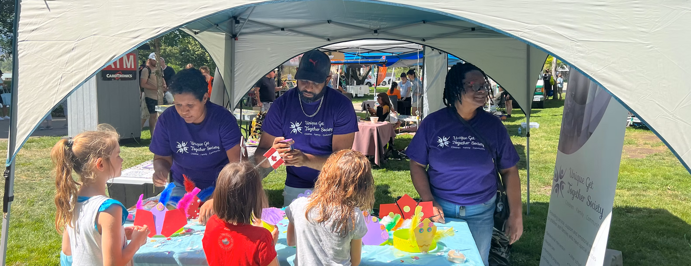 UGTS team members creating with children at a community event