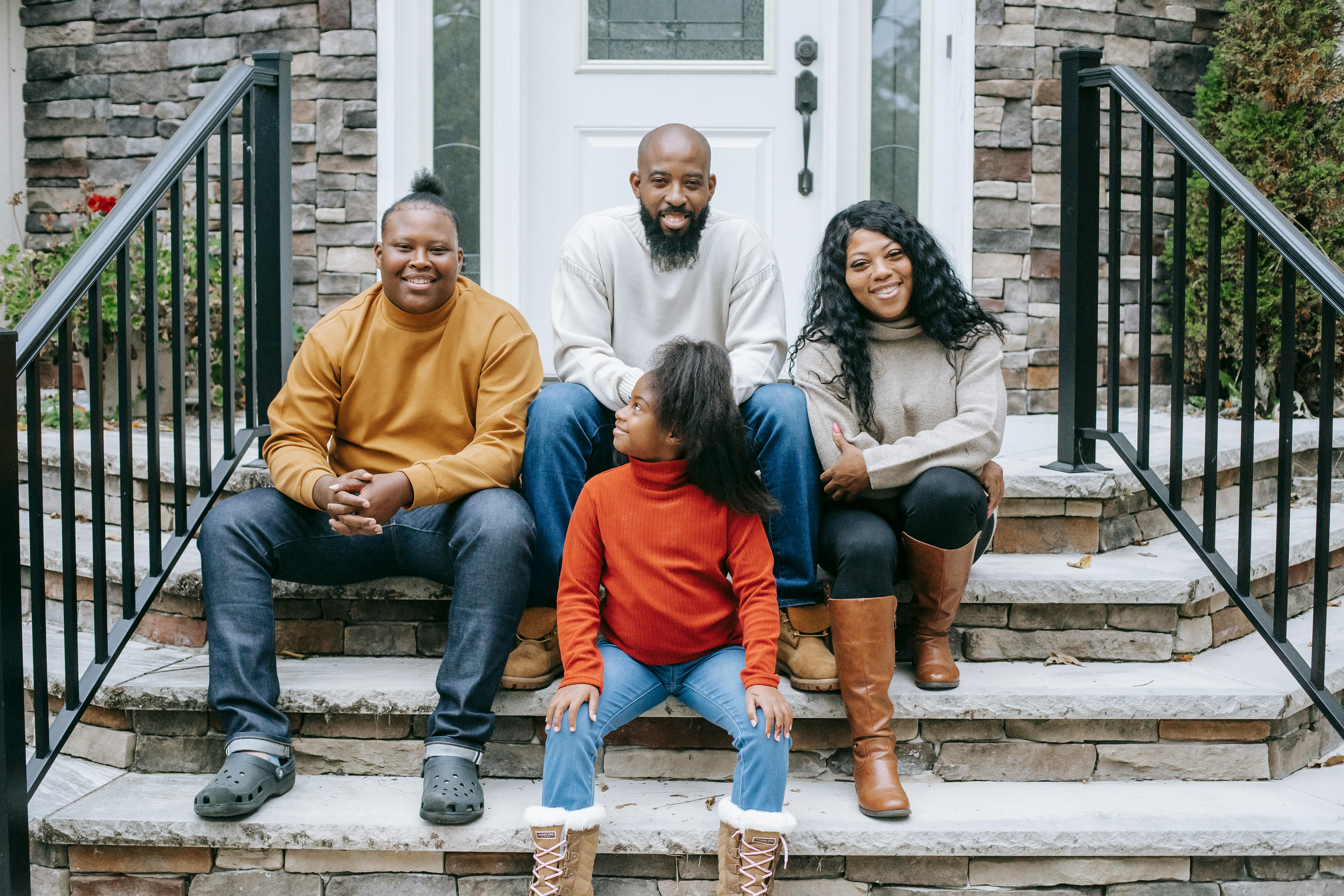 A diverse family gathered together outside their home