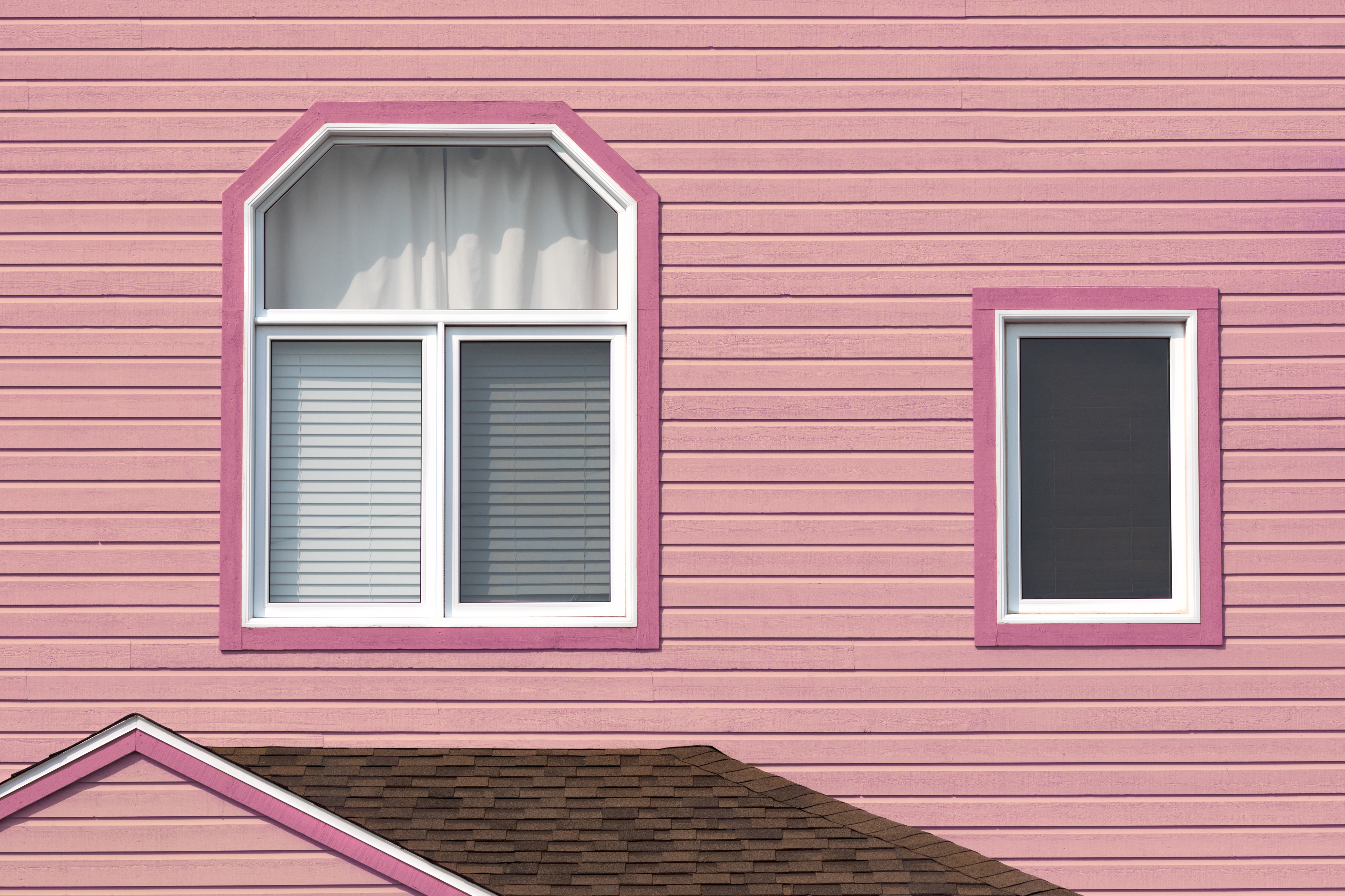 The windows of a welcoming pink home